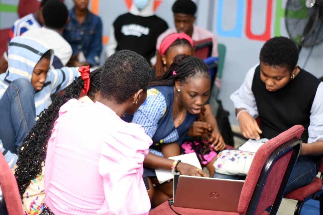 Children learning with laptops during a JENECONK Digital Academy bootcamp